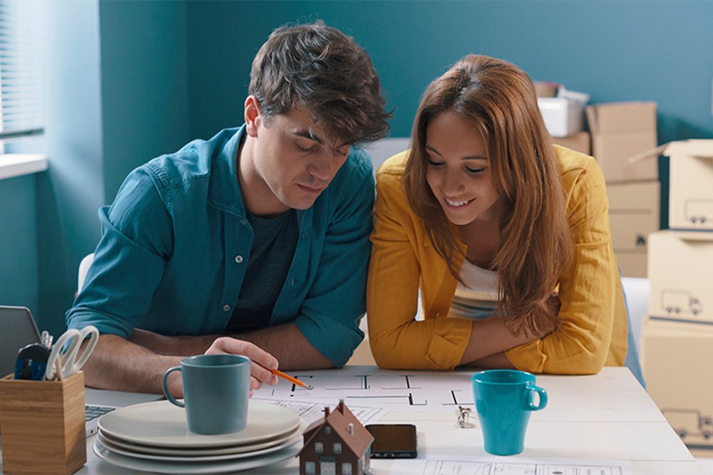 Couple reviewing papers on the table